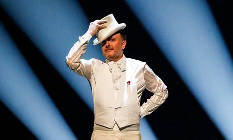 A picture of Chris McCausland with a white top hat. He is tipping the hat. From Strictly Come Dancing 2024. 
