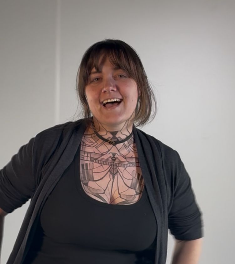 Jenn smiling while wearing a temporary tattoo of Sciel’s chestpiece from expedition 33