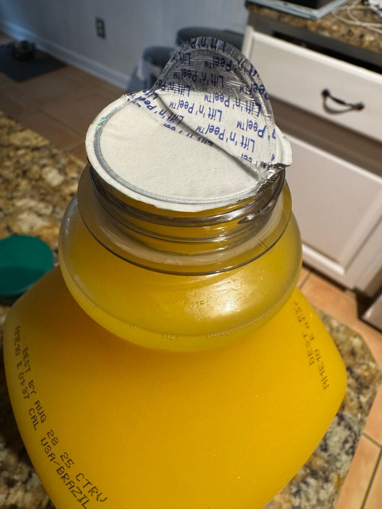 Lift and peel orange juice seal. 