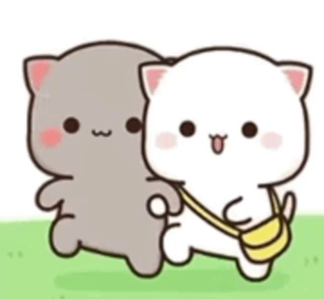 two cats are standing next to each other in the grass . one of the cats is carrying a yellow bag .