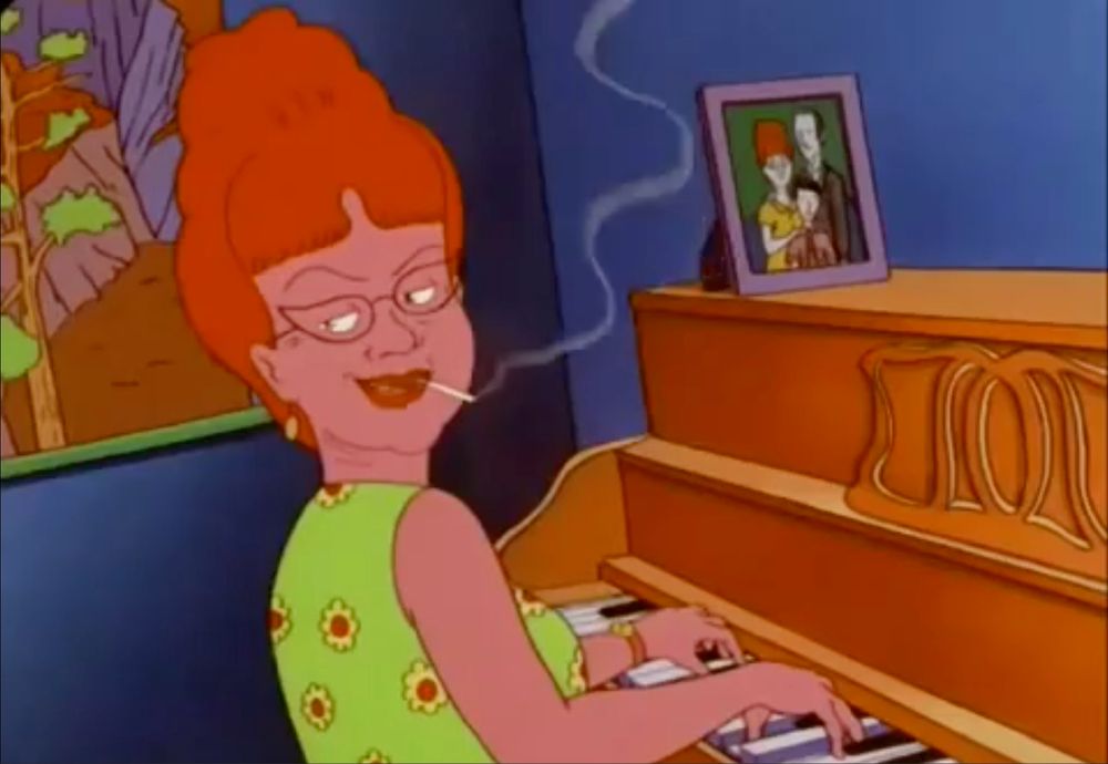 Dale Gribble, a character on King of the Hill, has a mom that looks like a ghost from the Real Ghostbusters. 
She is playing a piano, in a neon green dress, huge hair, glasses, and smoking a cigarette. 