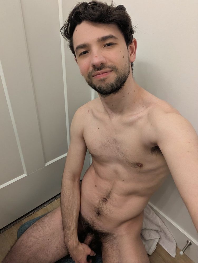 Kneeling on the floor naked looking up at you