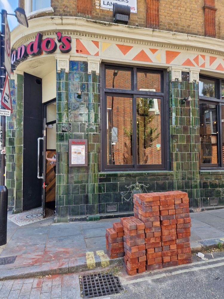 A pile of bricks outside a Nando's restaurant 