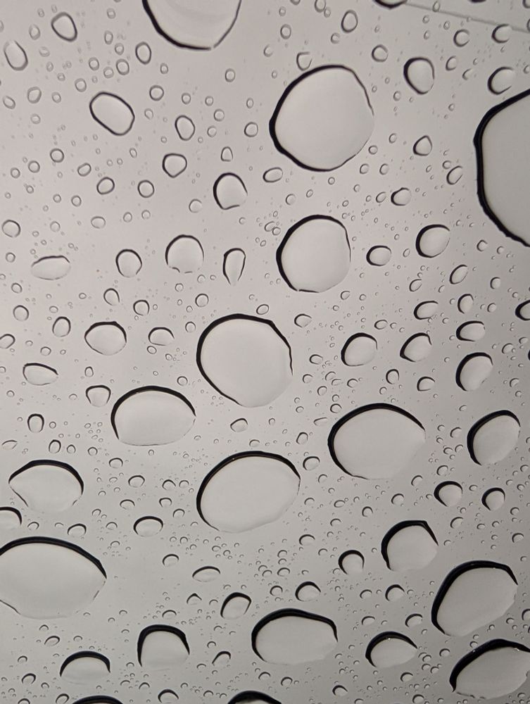 Rain collecting on a glass car roof
