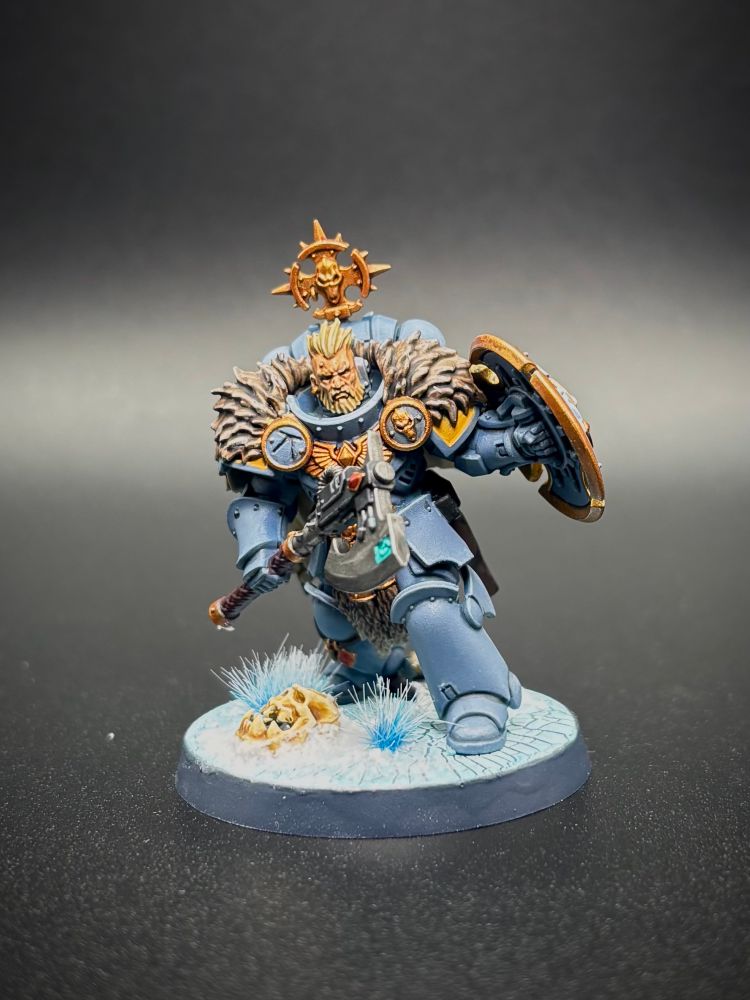 Blonde space wolf head taker with a beard, axe and shield on a black background. 