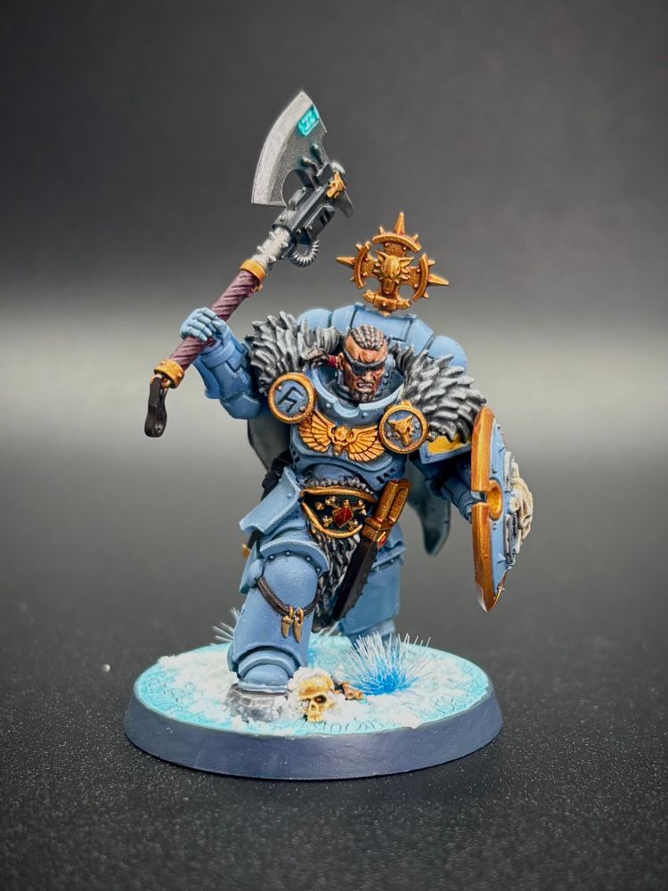 Space Wolf Head Taker with eye patch axe and shield on a black background