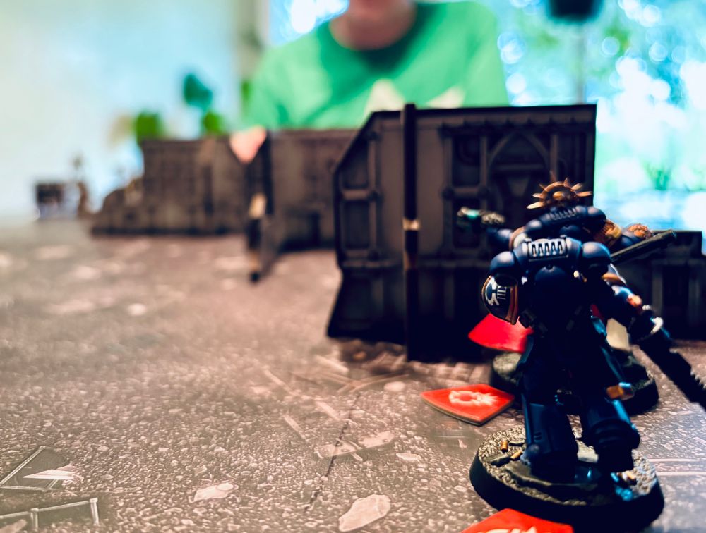 Ultra Marine mini behind some terrain.