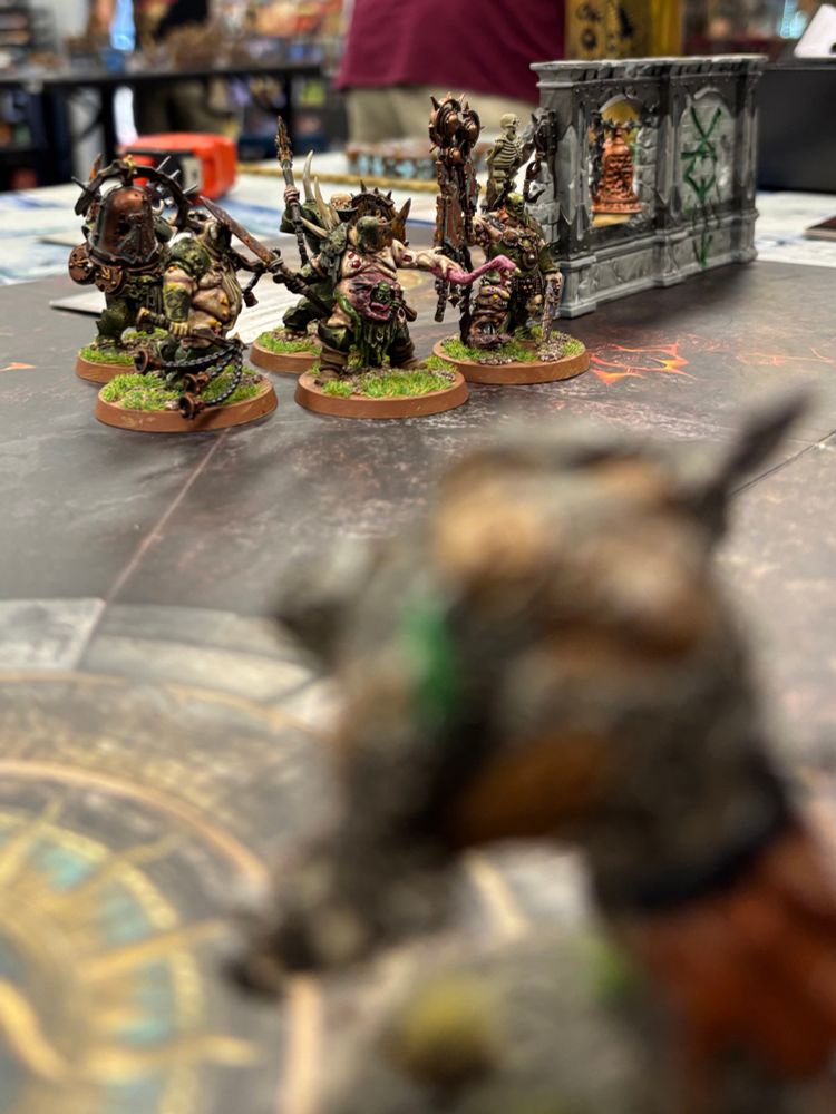 Unit of Nurgle fighters in background with Blurry rat ogre in foreground. 