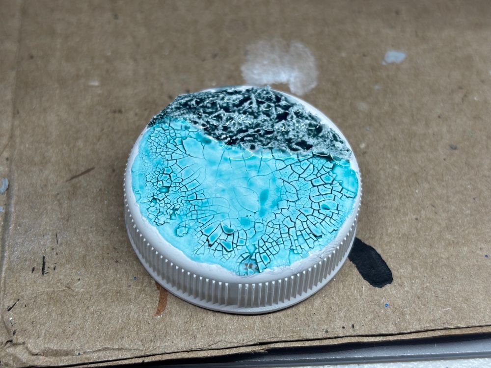 Fair Life lid with crackle paint painted on it as a test for painting icey bases for space wolves. 