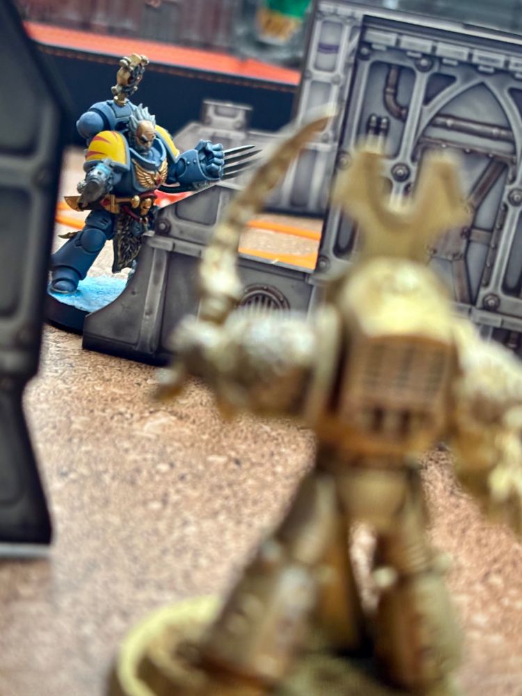 Gold Thousand Son terminator in foreground with Blood Claw captain in background. 