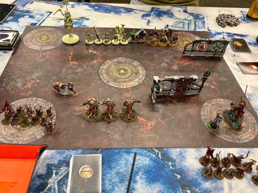 Age of Sigmar Spearhead game set up with minis on a board with some terrain.