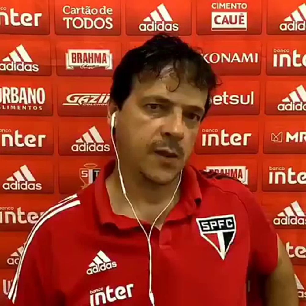 a man wearing earbuds and a red shirt with spfc on it