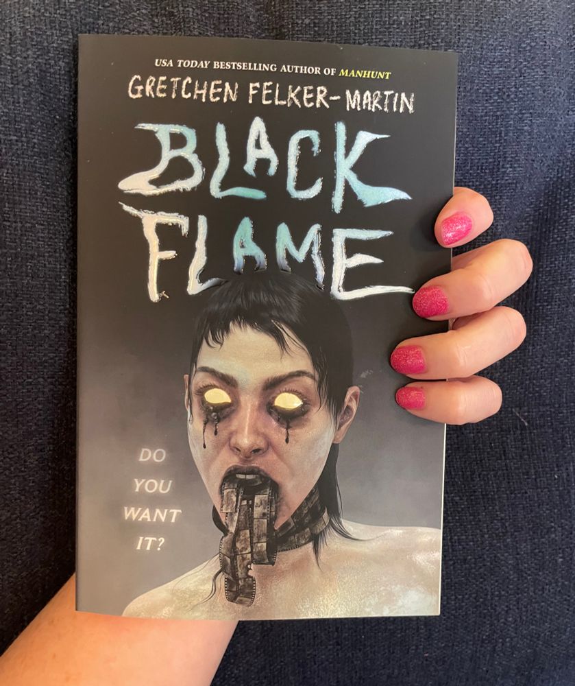 Black Flame by Gretchen Felker-Martin held in my pink-nailed hand