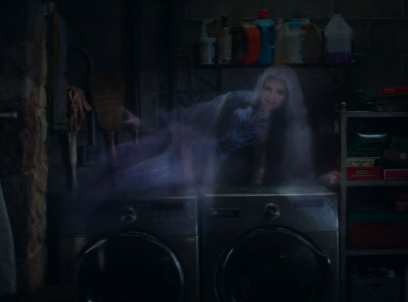 Agatha's ghost lounging atop a pair of washing machines.