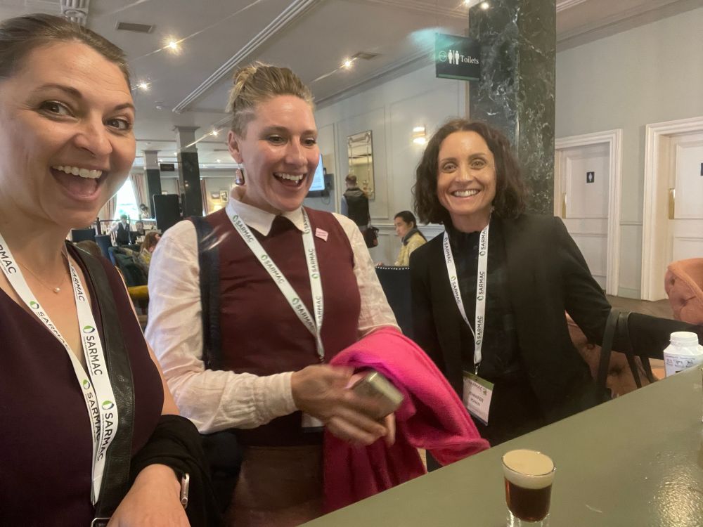 Three women with excited faces about to enjoy a “baby Guinness” shot after presenting  