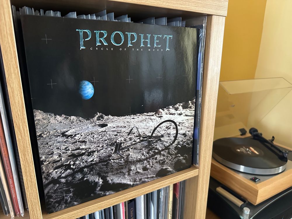 Album cover of Prophet “Cycle of the Moon.”  Cover depicts a photo of Earth taken from the moon’s surface with a broken bicycle in the foreground *groan*
