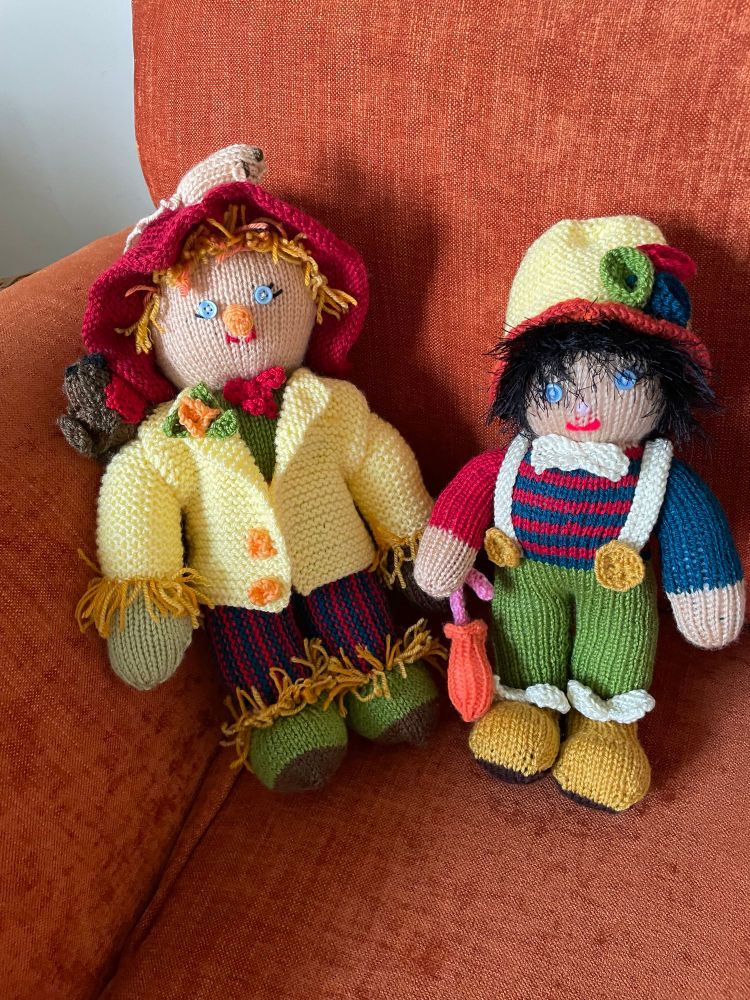 Photo shows a knitted scarecrow and a clown 