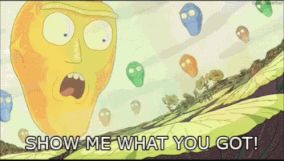 A clip from the Rick and Morty TV show in which a large golden head floats in the sky and exclaims "show me what you've got!". 
