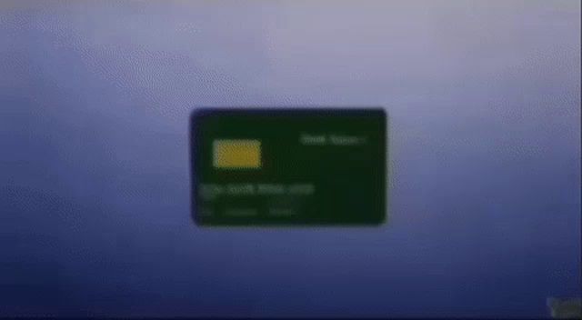 a green credit card with a yellow stripe on it