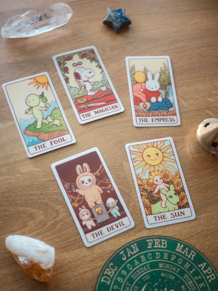 Photo of all Trinket Tarot sticker designs:

Smiski as The Fool
Snoopy as The Magician
Miffy as The Empress
Labubu as The Devil
Sonny Angel as The Sun