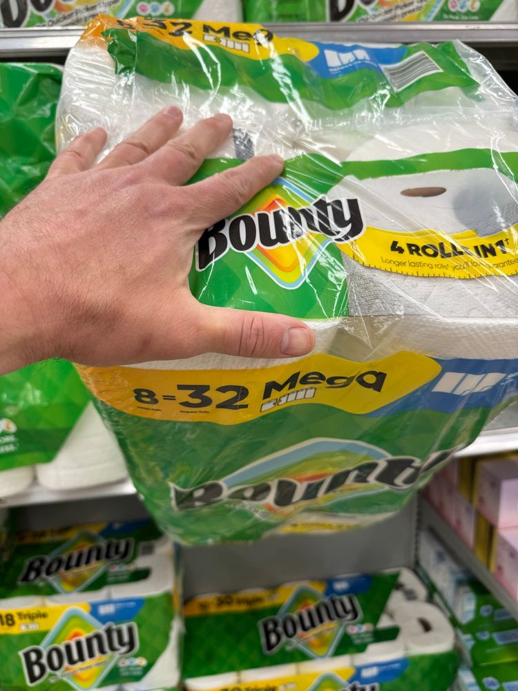 Hand measuring mega bounty paper towels
