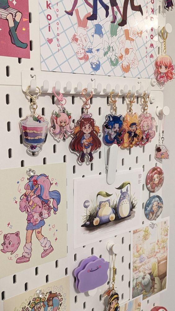 Pegboard featuring prints from Pokemon, and keychains from Naruto, Fruits Basket, etc