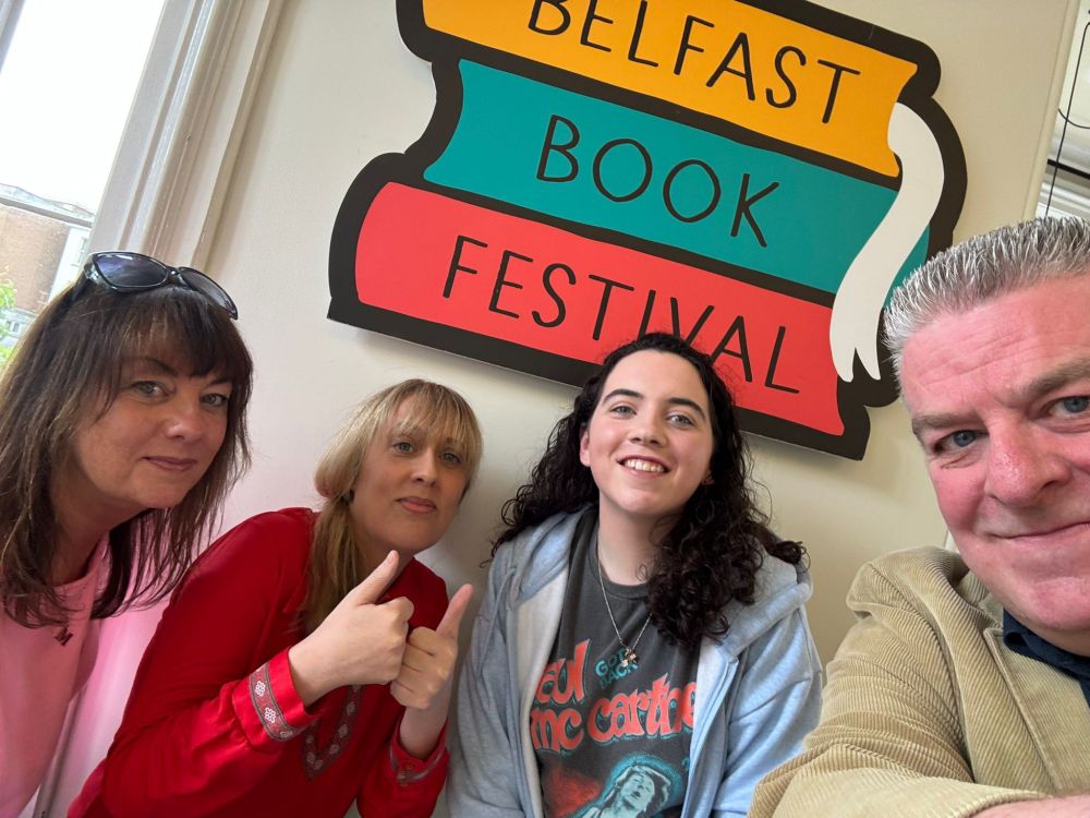 Michelle, me, Cáithlin & Damien in front of Belfast Book Festival sign. Thumbs aloft!