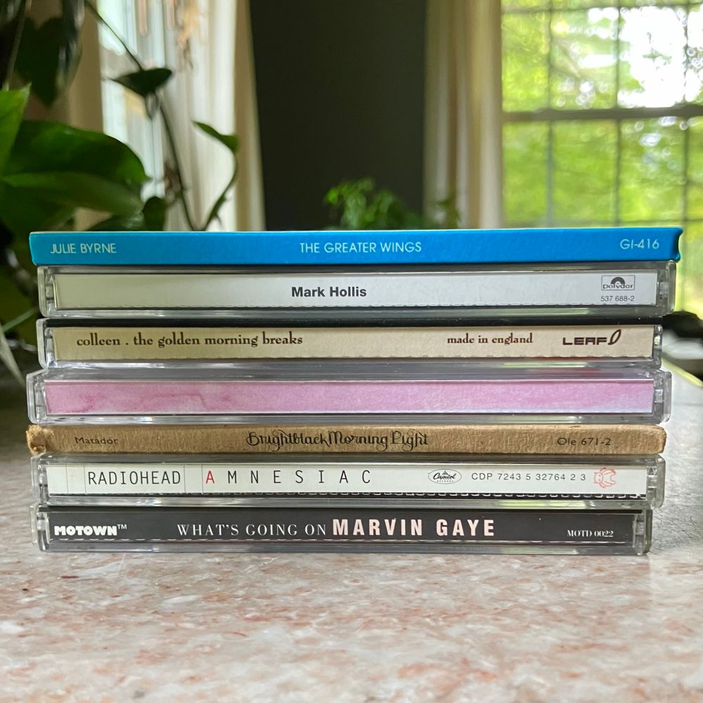 A stack of CDs:

Julie Byrne - The Greater Wings
Mark Hollis
Colleen - The Golden Morning Breaks
Colleen - Everyone Alive Wants Answers
Brightblack Morning Light
Radiohead - Amnesiac
Marvin Gaye - What’s Going On