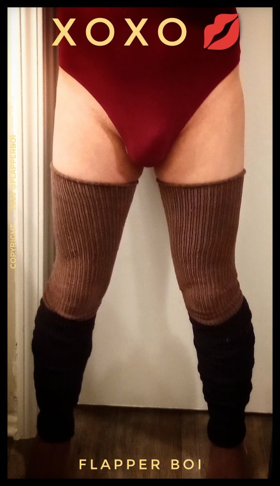 Photo of a femboy's lower body, with legs standing apart, and wearing a high cut bodysuit, with chocolate brown thigh high socks and black leg warmers .