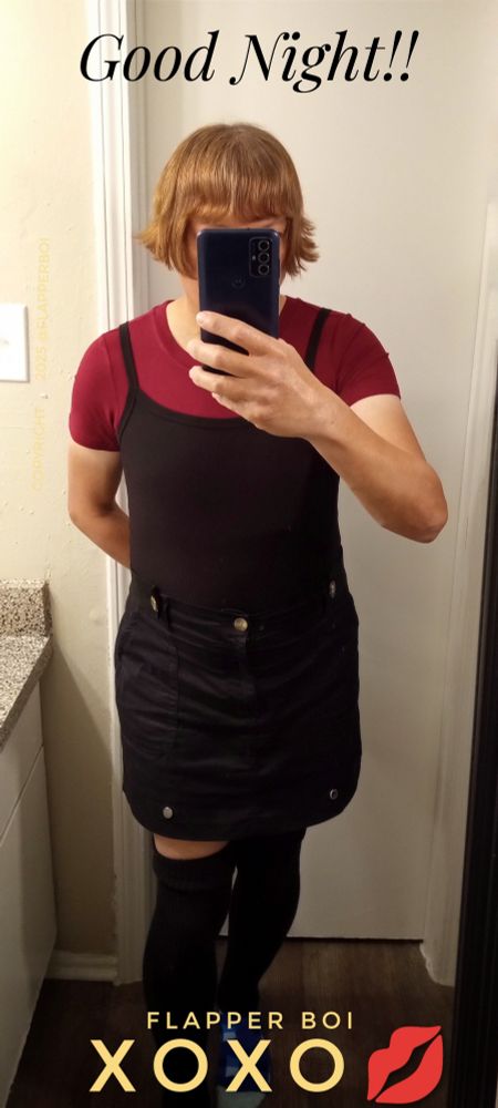 Picture of femboy wearing a burgundy red bodysuit under a black camisole, a black punk mini skirt and wearing black thigh high socks 