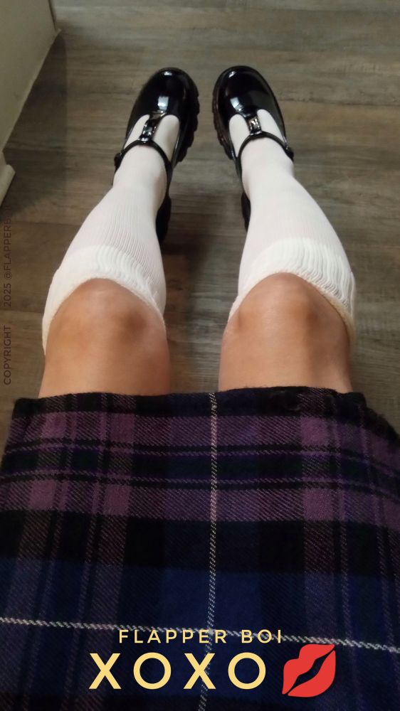 Picture of the lower body of a femboy wearing a Scottish Billie Kilt and white knee socks with black patent leather Mary Jane platform shoes.