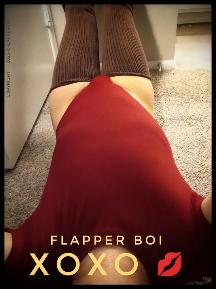 Picture of me lying on the carpet, wearing a burgundy red bodysuit with chocolate brown thigh high socks and black leg warmers