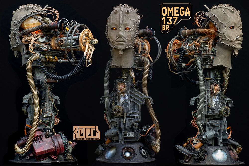 Three angles of a front show of a biomech head. Mostly human face attached to a core of electronic and mechanical wizardry. 99% reclaimed materials.