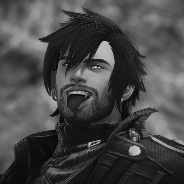 B&W closeup of Avy making a coy face and sticking his tongue out, showing off his sharp fangs.