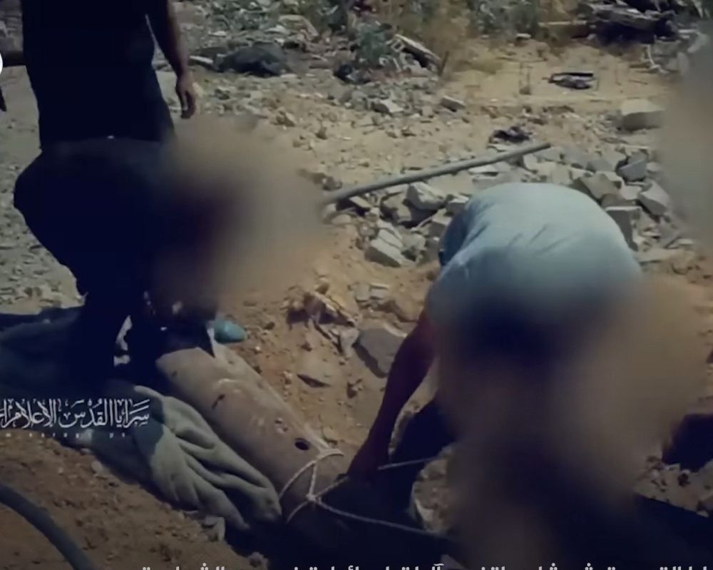 Hamas terrorist planting IED made from Israeli boom. 