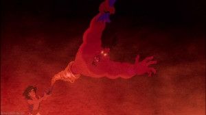 Still image from Disney's Aladdin, in which the horrified red genie Jafar is being sucked into a lamp Aladdin is holding up with a grin. 