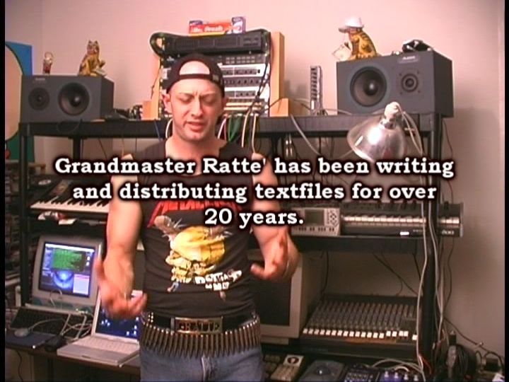 A man in a sleeveless metallica top stands in front of a multi-level audio workspace. Speakers, keyboards, mixers, monitors, a laptop and other gear fill the space. Text in the center of the image reads: "Grandmaster Ratte has been writing and distributing textfiles for over 20 years."