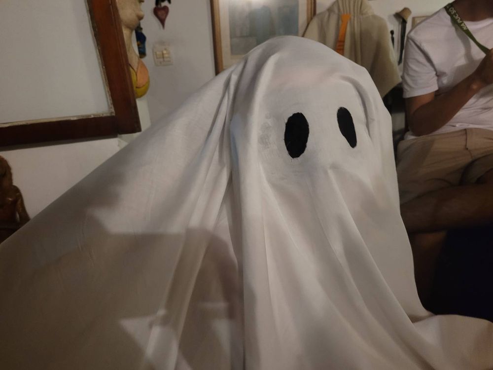 My S.O using the ghost costume looking at the camera already in the party