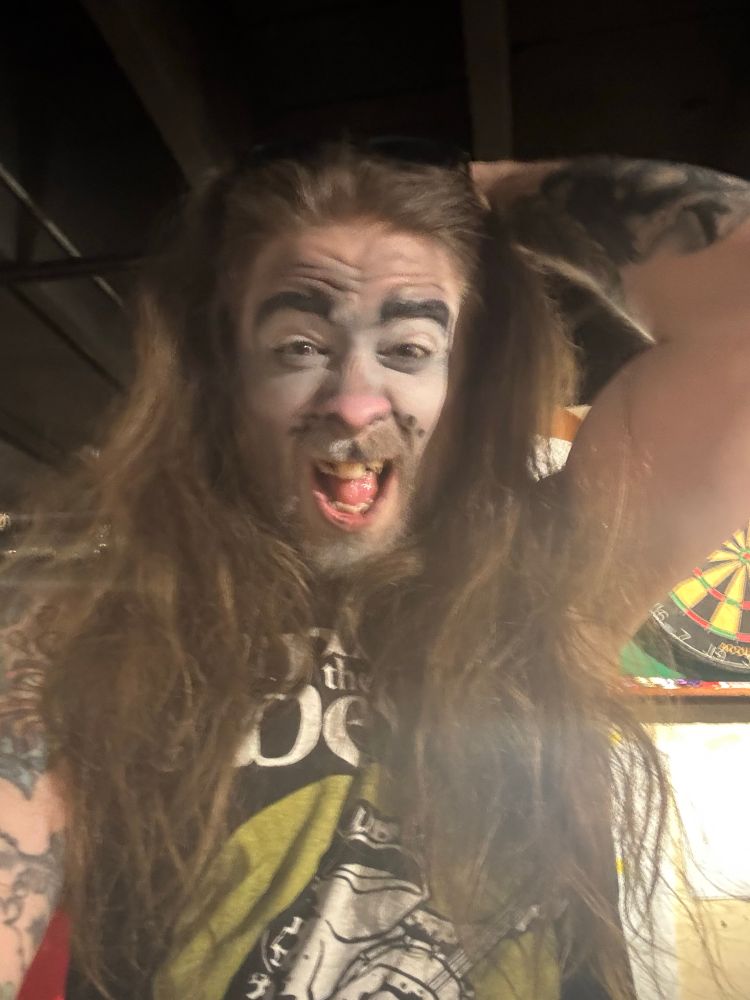 Worn off squirrel makeup on a gorgeous white fella with long hair like a lions mane. Also visually impaired people are amazingly cool. 