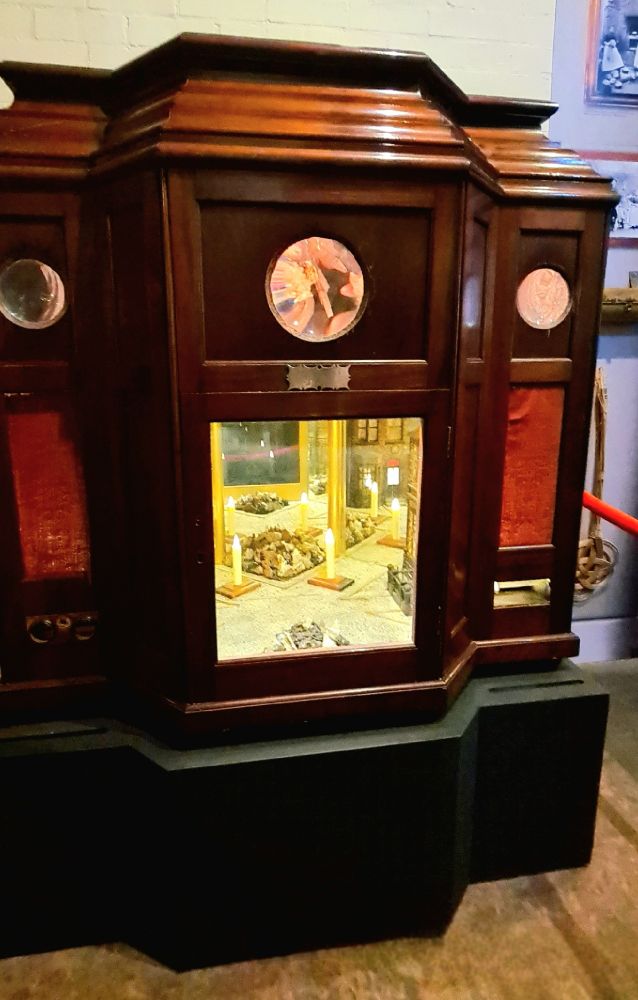 A wooden cabinet with complex crystal structures inside
