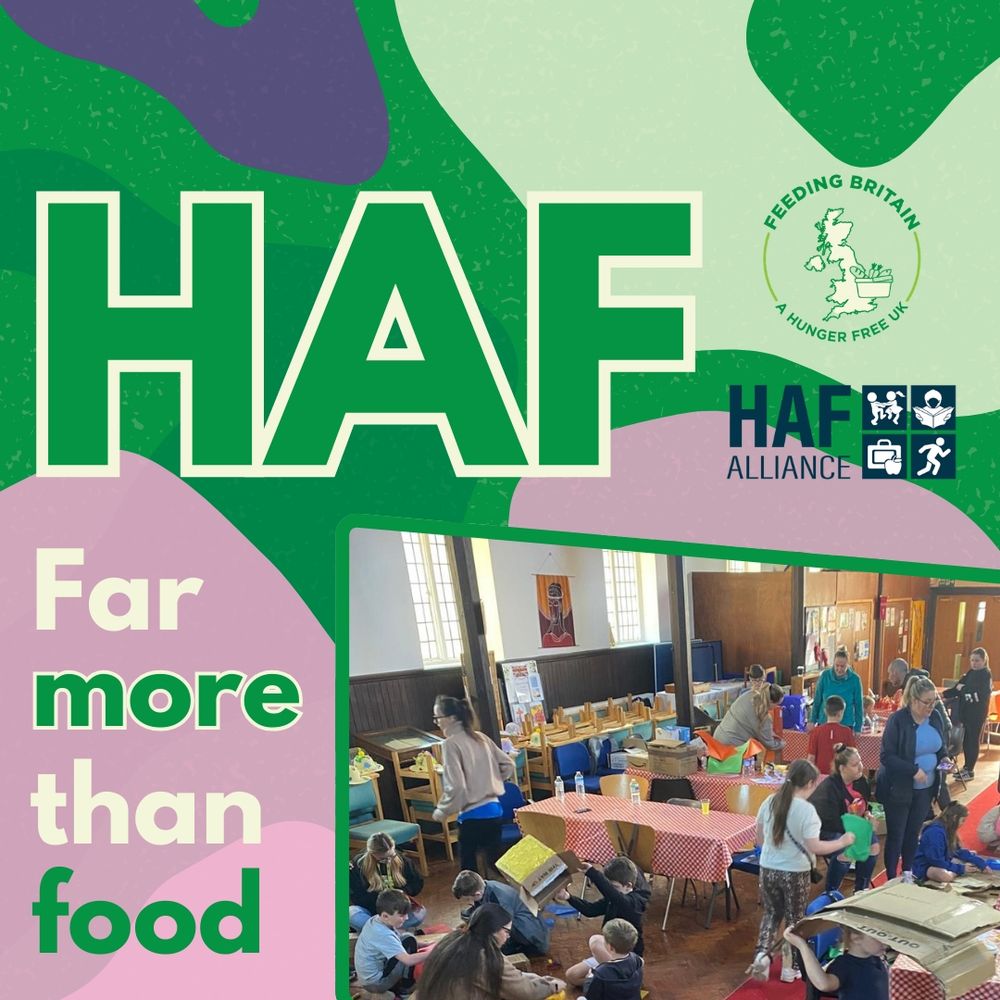 Graphic with large green text “HAF” and the Feeding Britain logo. The smaller text reads “Far more than food.” A photo shows children and adults inside a community hall, sitting at tables with craft materials and colourful tablecloths.
