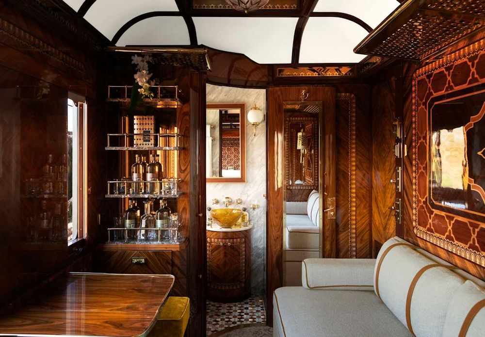 Photo of the incredible wood paneling of a living room in a luxury grand cabin suite on the Orient Express.