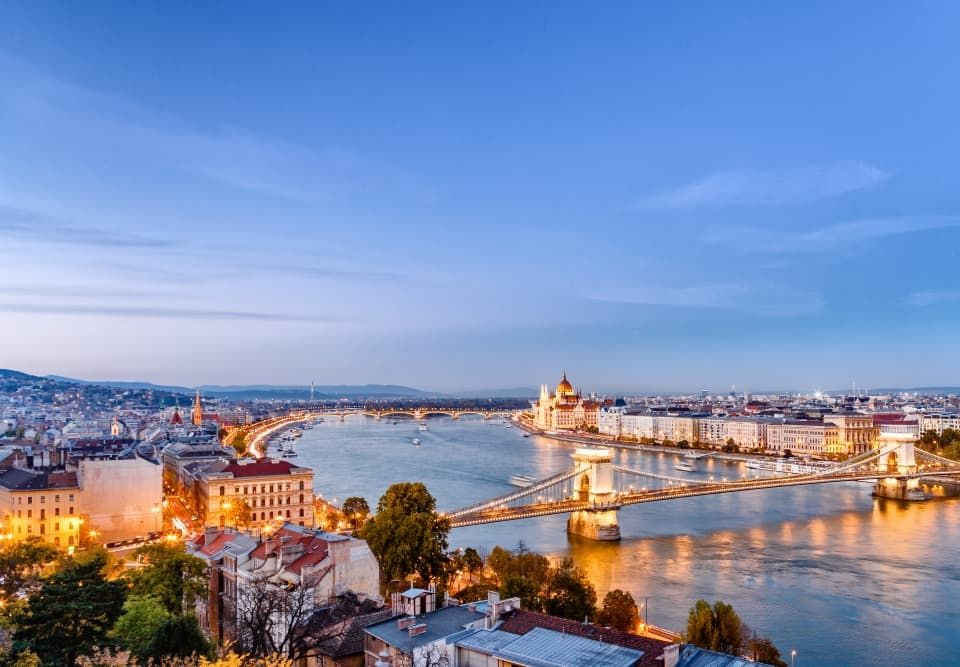 Photo of the Danube at sunset and of modern day Prague through which the train passes on its way to Paris.