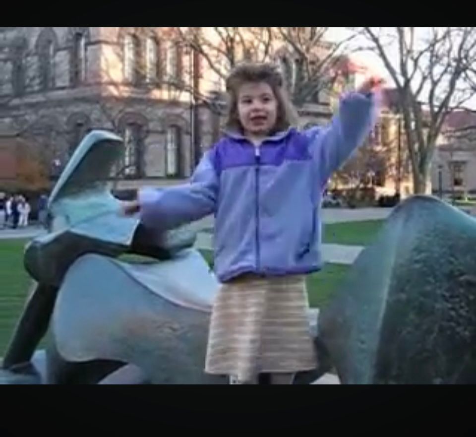 White girl age 5-ish giving a speech (just to me) atop a sculpture on the campus of Brown University.  c. 2007.  
