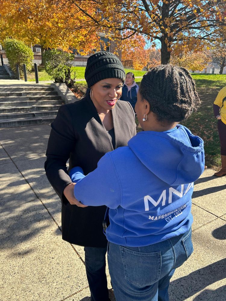 Rep Ayanna Pressley speaks with a voter in East Boston
