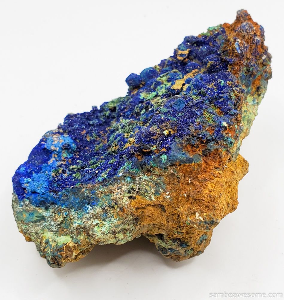 A stock photo close up of rock with azurite, a blue copper mineral covering the front-face of the rock.