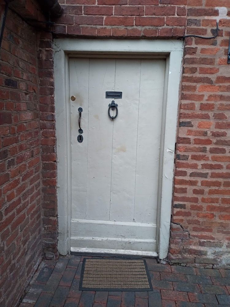 Circa 18th Century door and frame at Harvington Hall, Worcestershire.

Vertically boarded door with collection of weatherboards and heavy portal frame. 