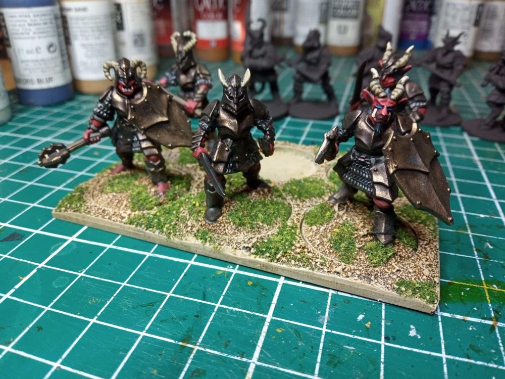 5 Frostgrave Demons with bronze plate armour and red flesh, and goat-like horns.