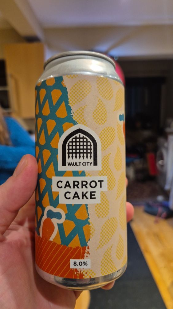 A hand holding a can of Vault City's Carrot Cake sour