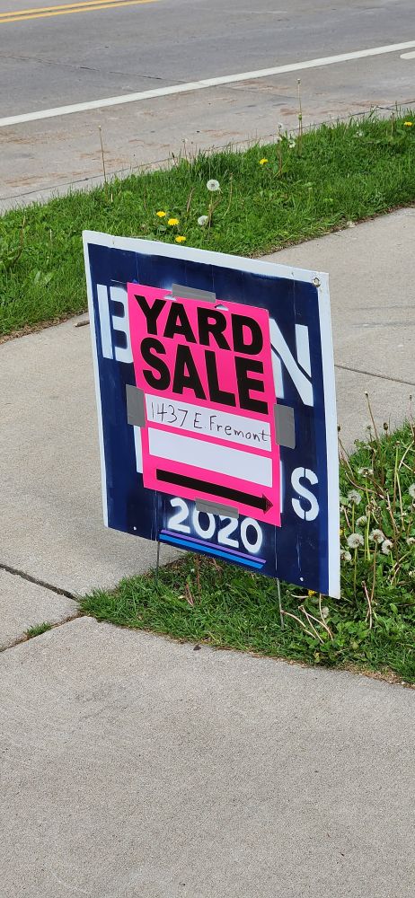 Yard sale sign posted using and old "Biden / Harris 2020" sign